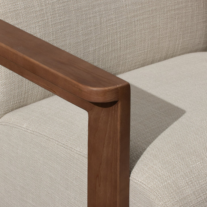 Corwin Occasional Chair Greige Our Corwin Occasional Armchair is mid-century inspired statement piece that blends sculptural elegance and grounded design. This unique upholstere chair features wooden arms that seamlessly extend into the base, eliminating