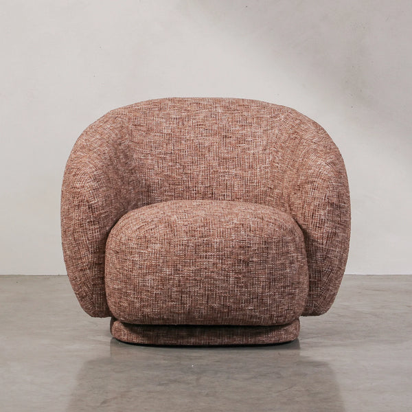 Aslan Occasional Chair Rust The Aslan Occasional Chair invites you to sink into plush comfort with its curved silhouette and soft, textured upholstery. This chair introduces a vibrant, multi-coloured fabric that adds bold personality while maintaining a r