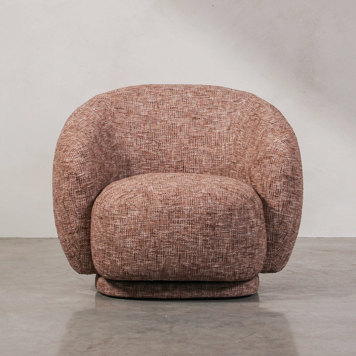 Aslan Occasional Chair Rust The Aslan Occasional Chair invites you to sink into plush comfort with its curved silhouette and soft, textured upholstery. This chair introduces a vibrant, multi-coloured fabric that adds bold personality while maintaining a r