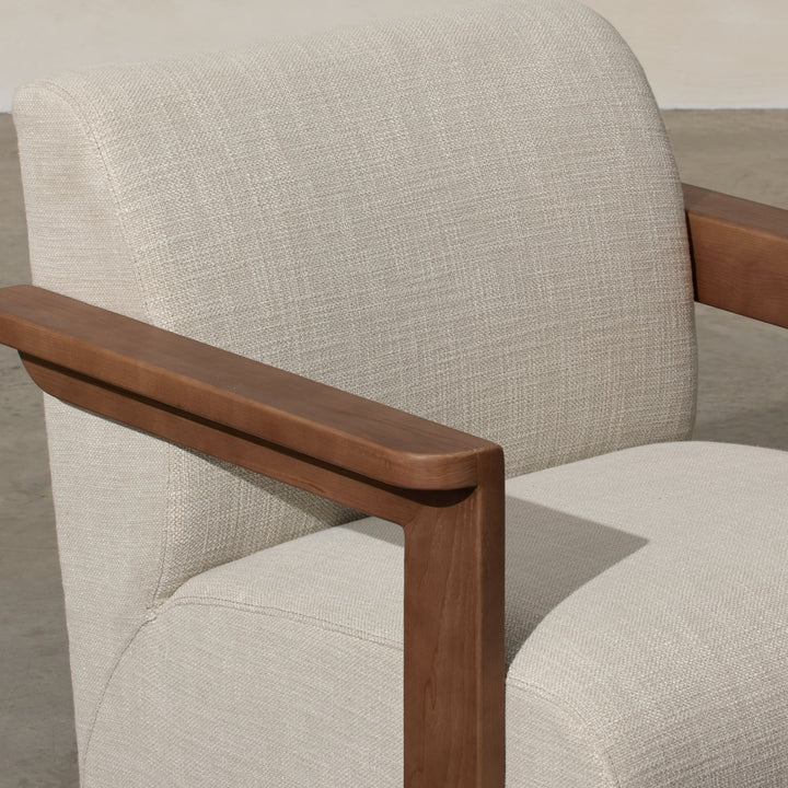 Corwin Occasional Chair Greige Our Corwin Occasional Armchair is mid-century inspired statement piece that blends sculptural elegance and grounded design. This unique upholstere chair features wooden arms that seamlessly extend into the base, eliminating