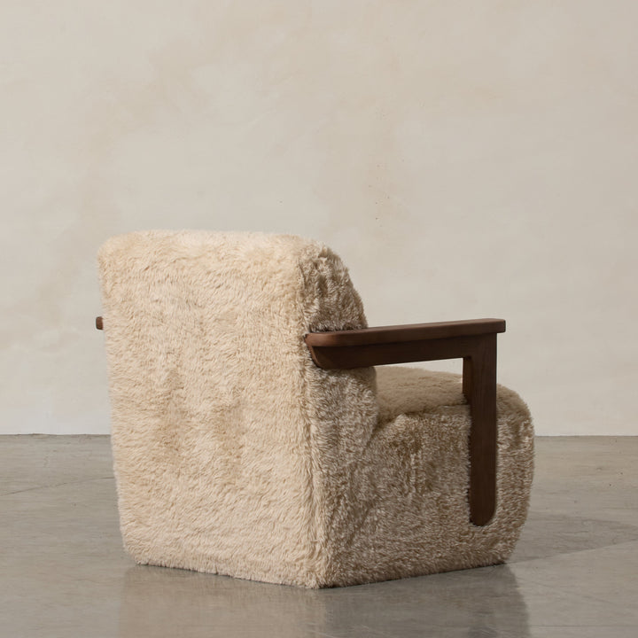 Corwin Occasional Chair Yakety Yak Our Corwin Occasional Armchair is mid-century inspired statement piece that blends sculptural elegance and grounded design. This unique upholstere chair features wooden arms that seamlessly extend into the base, eliminat