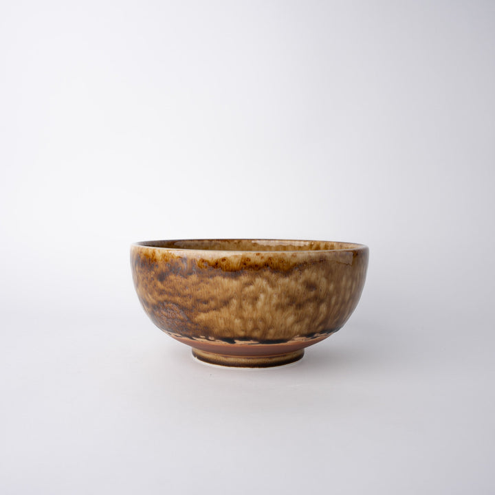 Artisan 19cm amber glaze bowl with slight irregularities in size, glaze and texture, showcasing its unique handmade quality.