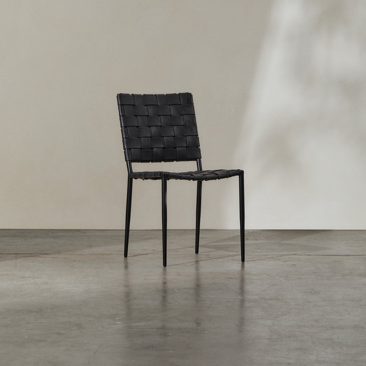 Batali Dining Chair Tan featuring woven leather strapping and a sleek metal frame for contemporary dining.