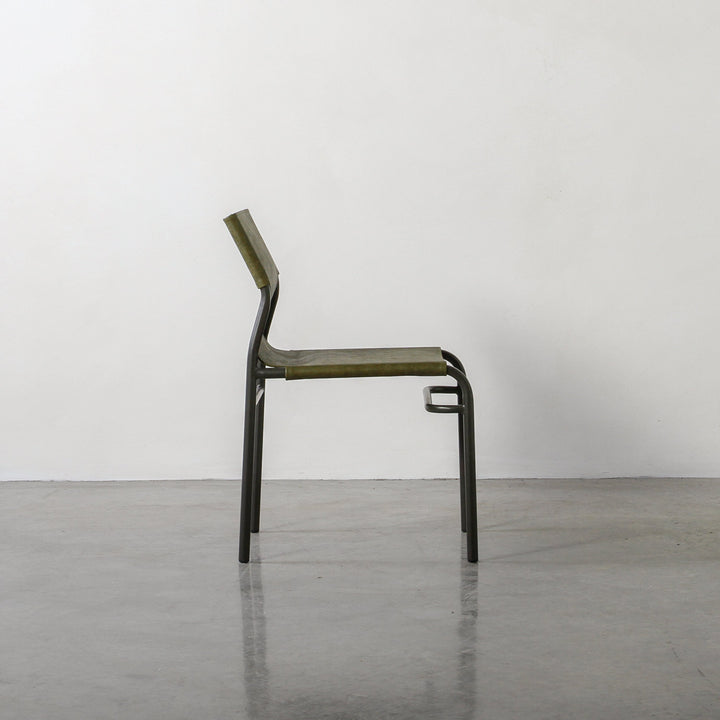 Fieri Dining Chair Olive showcasing industrial design with olive leather upholstery and metal frame in elegant side profile view.
