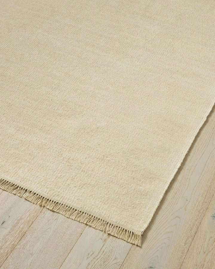Emilio Canvas - Premium Linen Rug for Your Home Emilio Canvas is a light beige-cream rug that adds natural elegance and charm to any space with its refined design.