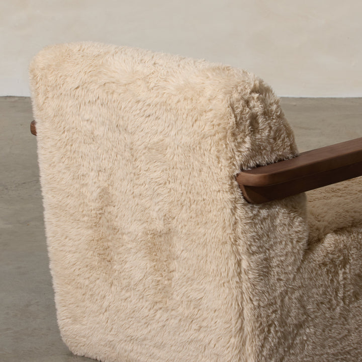 Corwin Occasional Chair Yakety Yak Our Corwin Occasional Armchair is mid-century inspired statement piece that blends sculptural elegance and grounded design. This unique upholstere chair features wooden arms that seamlessly extend into the base, eliminat