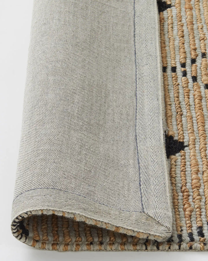 Denali Sandstorm - Weave This beautiful Denali rug boasts a unique hand-woven aesthetic and a repetitive diamond pattern. Its elegant design is versatile and complements striking furniture and metallic accents. Made from a combination of 50% wool and 50%