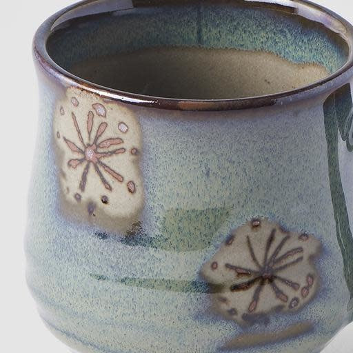 Artisan green mug with leaf design, 8cm tall, 225ml, showcasing unique glaze and texture patterns.