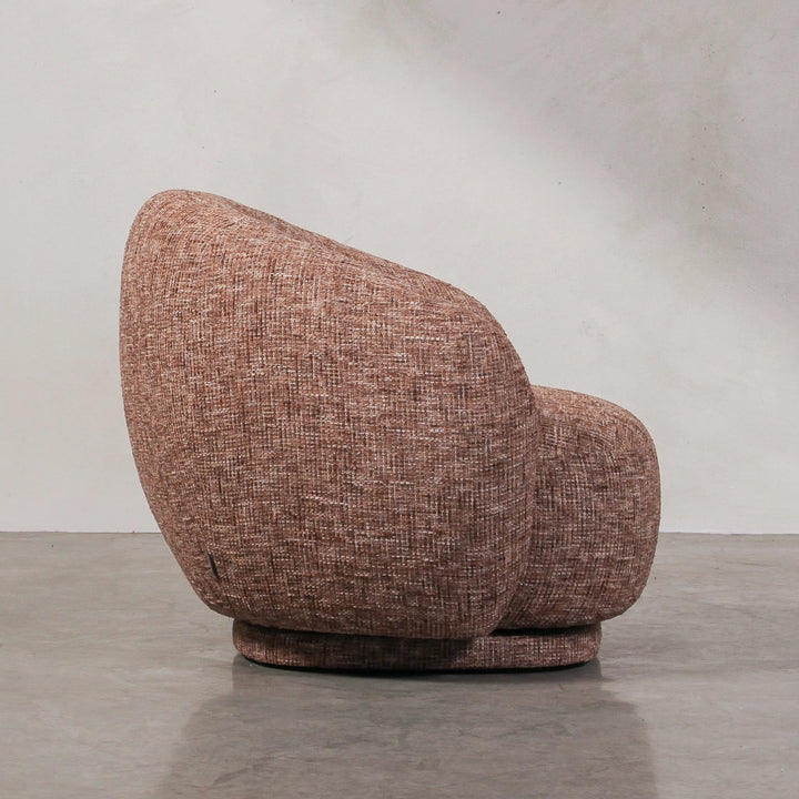 Aslan Occasional Chair Rust The Aslan Occasional Chair invites you to sink into plush comfort with its curved silhouette and soft, textured upholstery. This chair introduces a vibrant, multi-coloured fabric that adds bold personality while maintaining a r