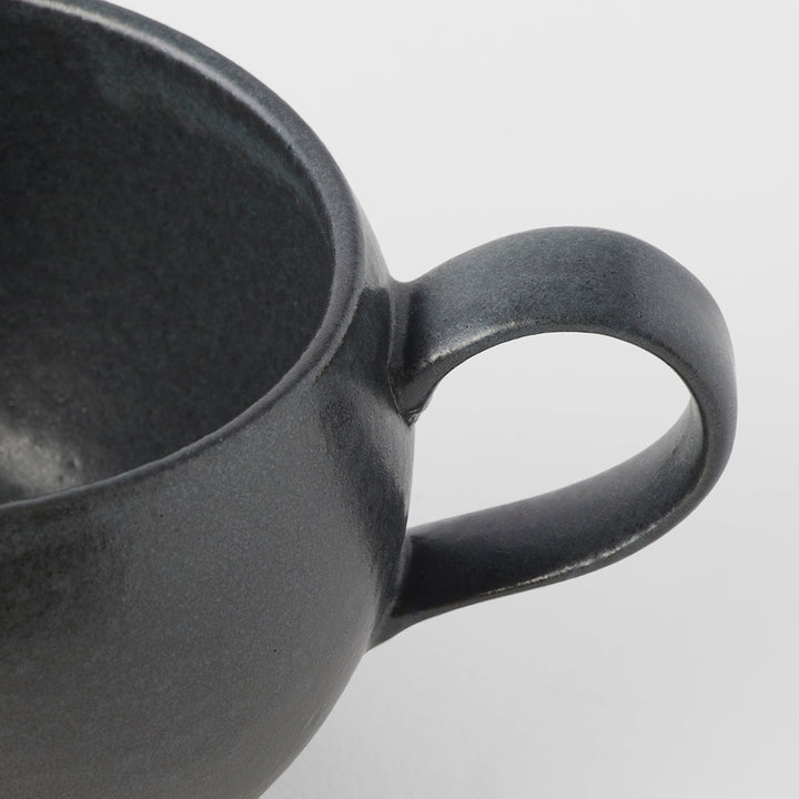 Close-up of a black glaze sphere mug with handle, ideal for tea and coffee from Mr Marunaka's artisan collection.