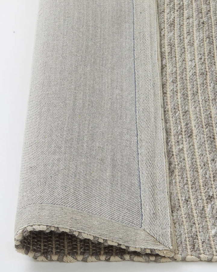 Andes Feather One of our most popular rugs, Andes is a hand-woven textured floor rug featuring a ribbed design — the range bringing a coastal vibe with beautiful visual interest. Made from 50% Wool and 50% Cotton, Andes uses chunky spun wool yarn and warp