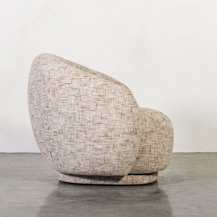 Aslan Occasional Chair Tawny The Aslan Occasional Chair invites you to sink into plush comfort with its curved silhouette and soft, textured upholstery. This chair introduces a vibrant, multi-coloured fabric that adds bold personality while maintaining a