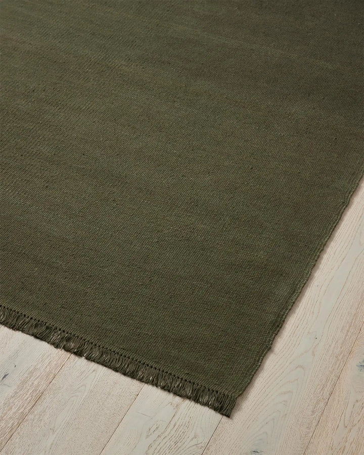 Emilio Kale - Premium Flat-Weave Linen Rug Transform your space with the Emilio Kale rug. Its deep forest green hue and fringe details offer effortless sophistication.