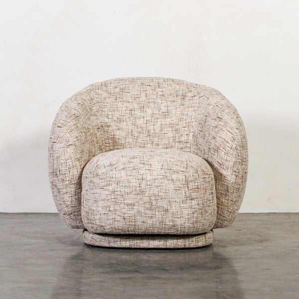 Aslan Occasional Chair Tawny The Aslan Occasional Chair invites you to sink into plush comfort with its curved silhouette and soft, textured upholstery. This chair introduces a vibrant, multi-coloured fabric that adds bold personality while maintaining a