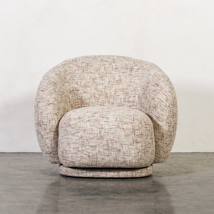 Aslan Occasional Chair Tawny The Aslan Occasional Chair invites you to sink into plush comfort with its curved silhouette and soft, textured upholstery. This chair introduces a vibrant, multi-coloured fabric that adds bold personality while maintaining a