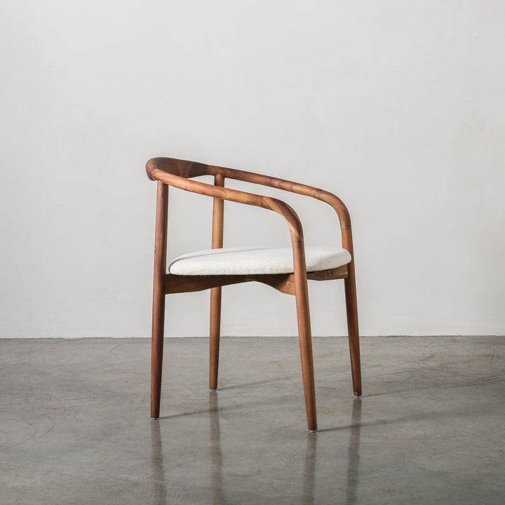 Essence Dining Chair Fabric/Walnut showcasing curved Acacia wood frame and soft fabric upholstery.
