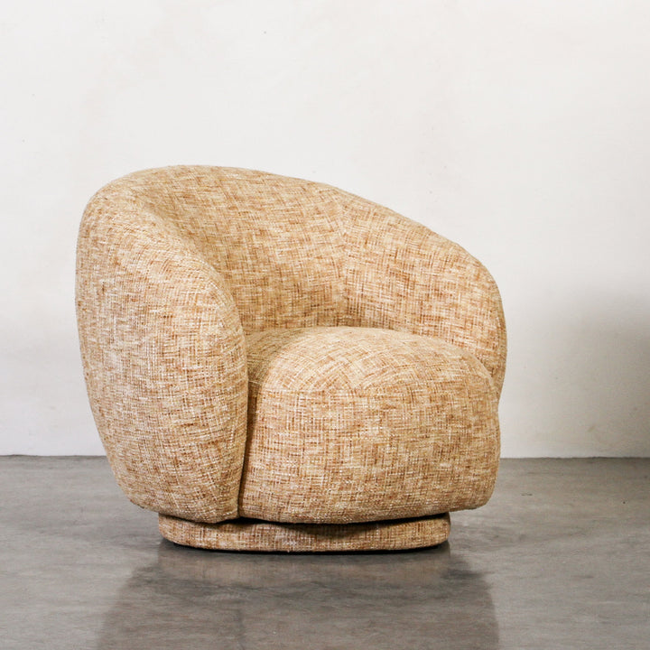 Aslan Occasional Chair Honey The Aslan Occasional Chair invites you to sink into plush comfort with its curved silhouette and soft, textured upholstery. This chair introduces a vibrant, multi-coloured fabric that adds bold personality while maintaining a