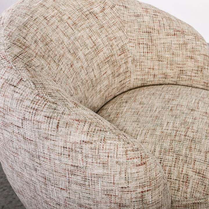 Aslan Occasional Chair Tawny The Aslan Occasional Chair invites you to sink into plush comfort with its curved silhouette and soft, textured upholstery. This chair introduces a vibrant, multi-coloured fabric that adds bold personality while maintaining a