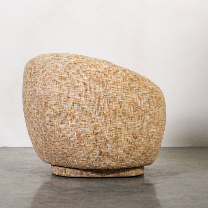 Aslan Occasional Chair Honey The Aslan Occasional Chair invites you to sink into plush comfort with its curved silhouette and soft, textured upholstery. This chair introduces a vibrant, multi-coloured fabric that adds bold personality while maintaining a