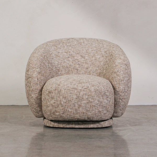 Aslan Occasional Chair Stone The Aslan Occasional Chair invites you to sink into plush comfort with its curved silhouette and soft, textured upholstery. This chair introduces a vibrant, multi-coloured fabric that adds bold personality while maintaining a