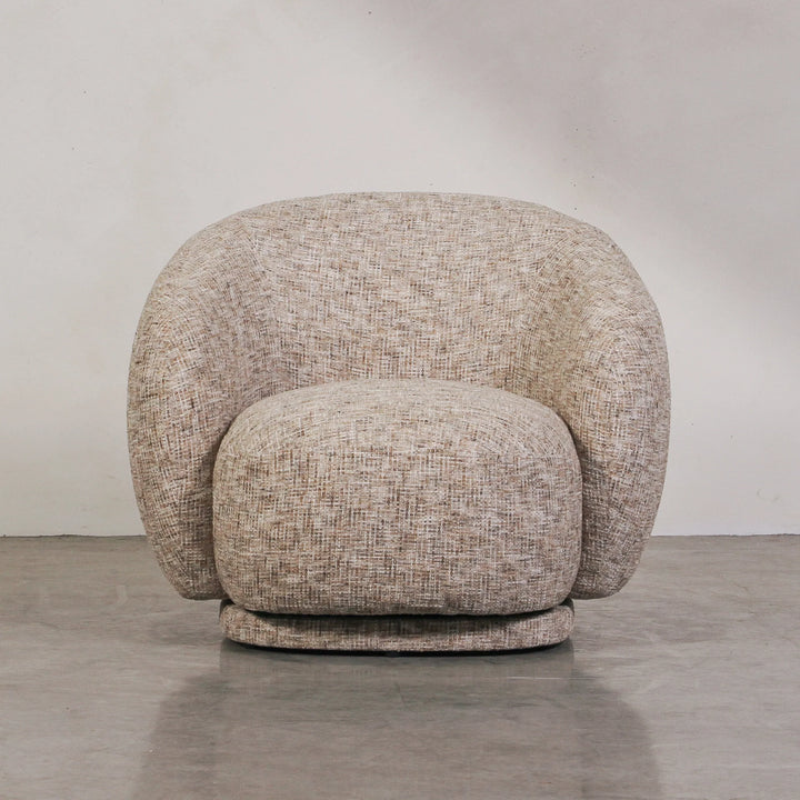 Aslan Occasional Chair Stone The Aslan Occasional Chair invites you to sink into plush comfort with its curved silhouette and soft, textured upholstery. This chair introduces a vibrant, multi-coloured fabric that adds bold personality while maintaining a