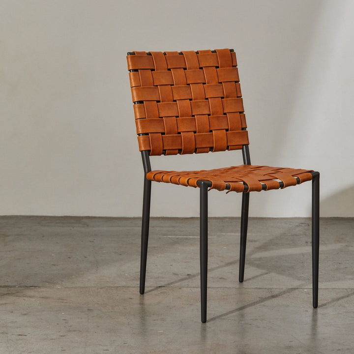 Batali Dining Chair Tan features woven leather strapping and a geometric grid design, perfect for contemporary dining settings.