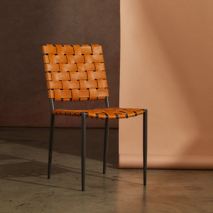 Batali Dining Chair Tan with woven leather strapping and metal frame in contemporary setting.