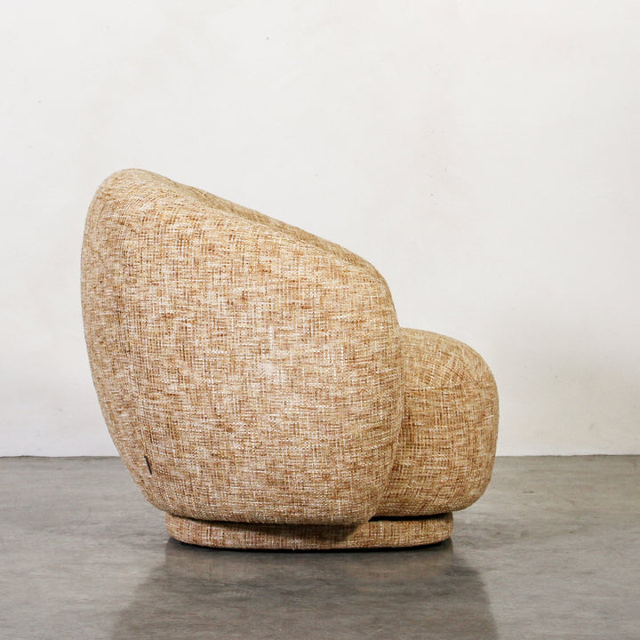 Aslan Occasional Chair Honey The Aslan Occasional Chair invites you to sink into plush comfort with its curved silhouette and soft, textured upholstery. This chair introduces a vibrant, multi-coloured fabric that adds bold personality while maintaining a