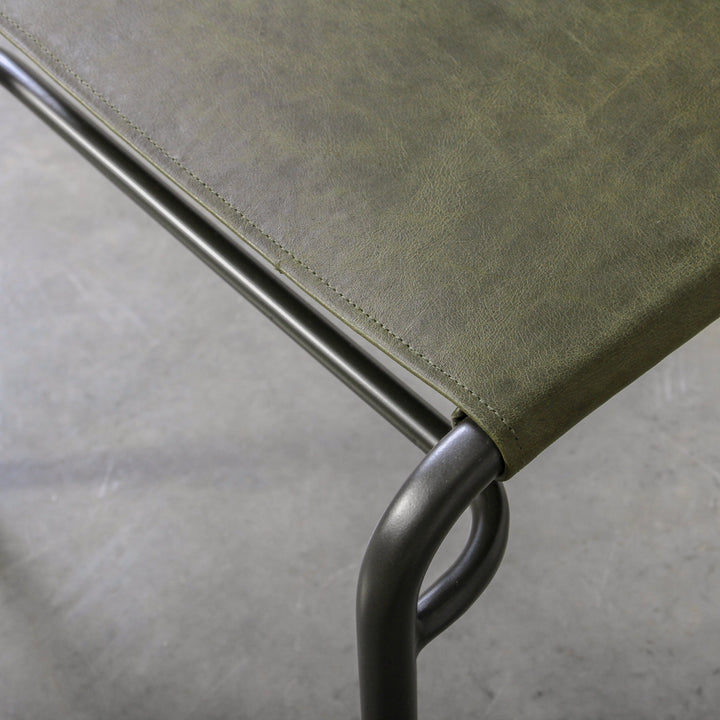 Fieri Dining Chair Olive with olive leather upholstery and industrial metal frame detail.