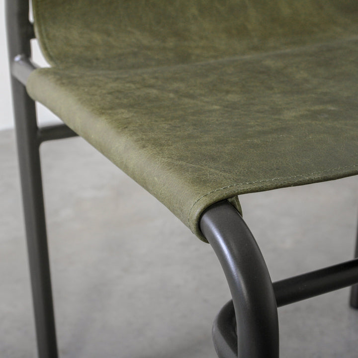 Fieri Dining Chair Olive showing olive leather upholstery and industrial metal framework.