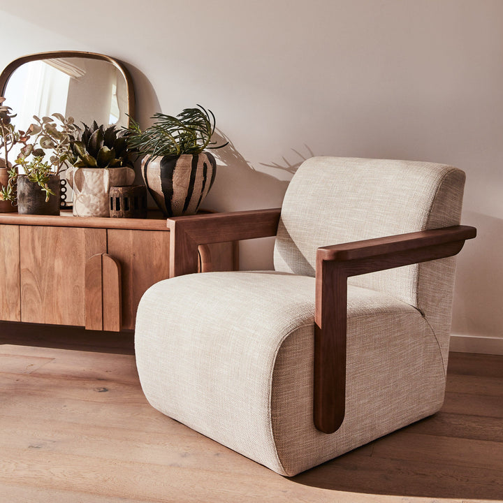 Corwin Occasional Chair Greige Our Corwin Occasional Armchair is mid-century inspired statement piece that blends sculptural elegance and grounded design. This unique upholstere chair features wooden arms that seamlessly extend into the base, eliminating