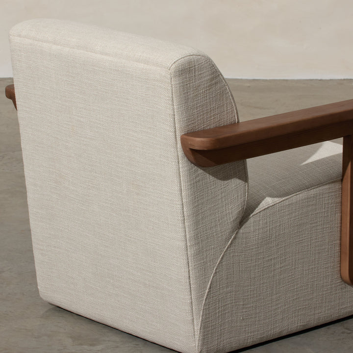 Corwin Occasional Chair Greige Our Corwin Occasional Armchair is mid-century inspired statement piece that blends sculptural elegance and grounded design. This unique upholstere chair features wooden arms that seamlessly extend into the base, eliminating
