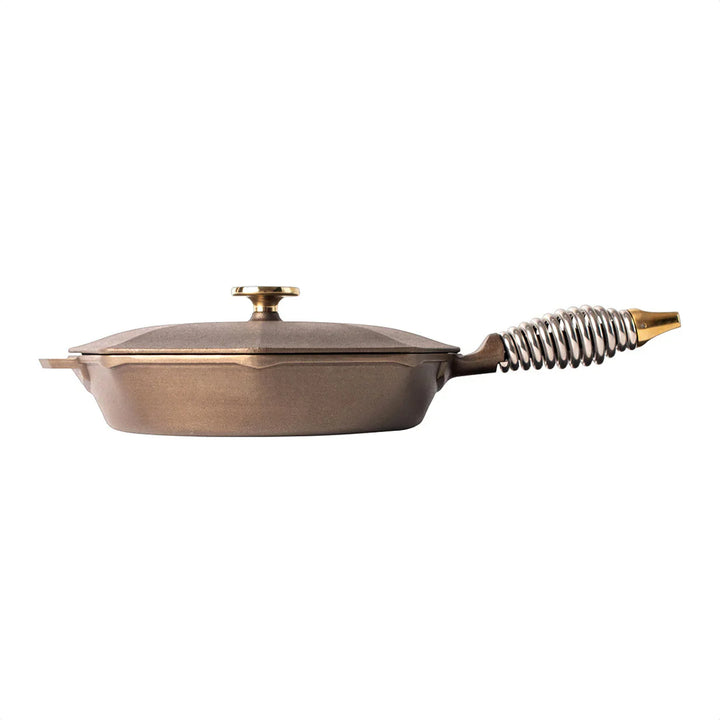FINEX cast iron skillet with octagonal shape and unique spring handle design, pre-seasoned for effortless cooking.