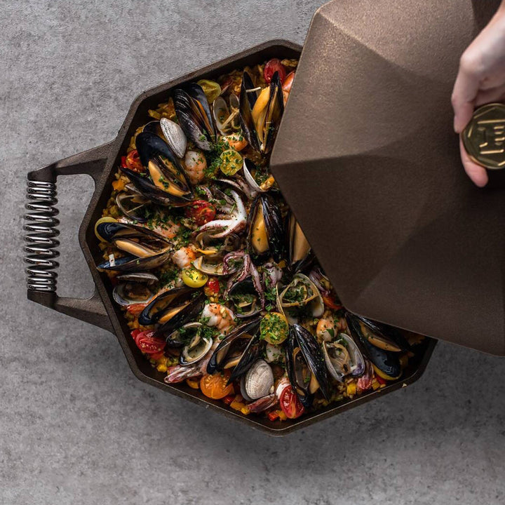 Delicious seafood paella in a FINEX cast iron skillet with octagonal shape and polished surface.