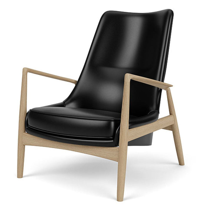 The Seal High Back Lounge Chair by Audo Copenhagen - Arguably one of Ib Kofod-Larsen's best-known designs, The Seal is an elegant armchair typical of its time – and yet entirely timeless. The angled frame and armrests and leather upholstery put comfort at