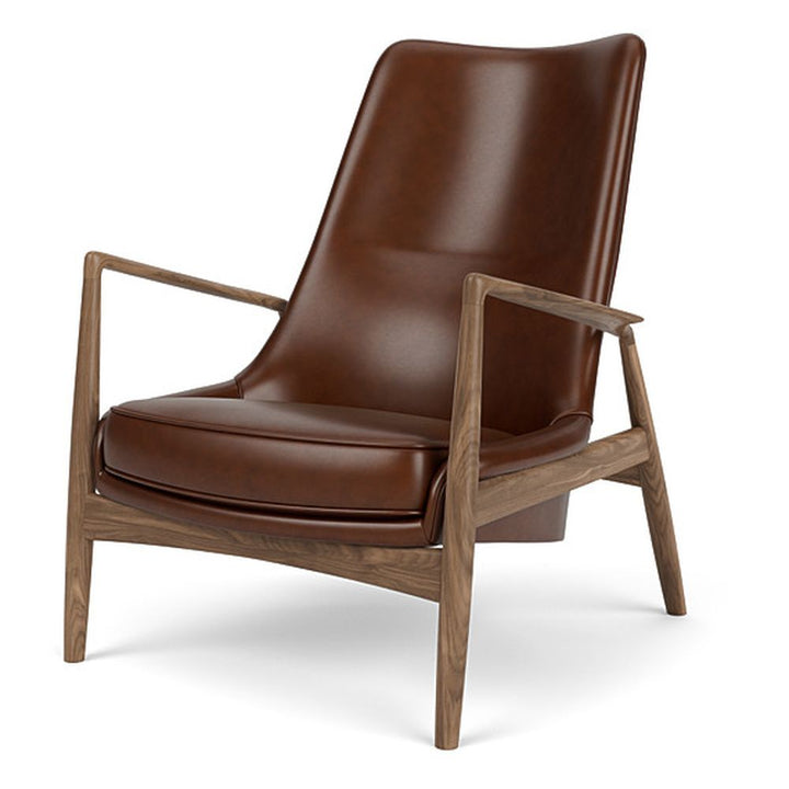 The Seal High Back Lounge Chair by Audo Copenhagen - Arguably one of Ib Kofod-Larsen's best-known designs, The Seal is an elegant armchair typical of its time – and yet entirely timeless. The angled frame and armrests and leather upholstery put comfort at