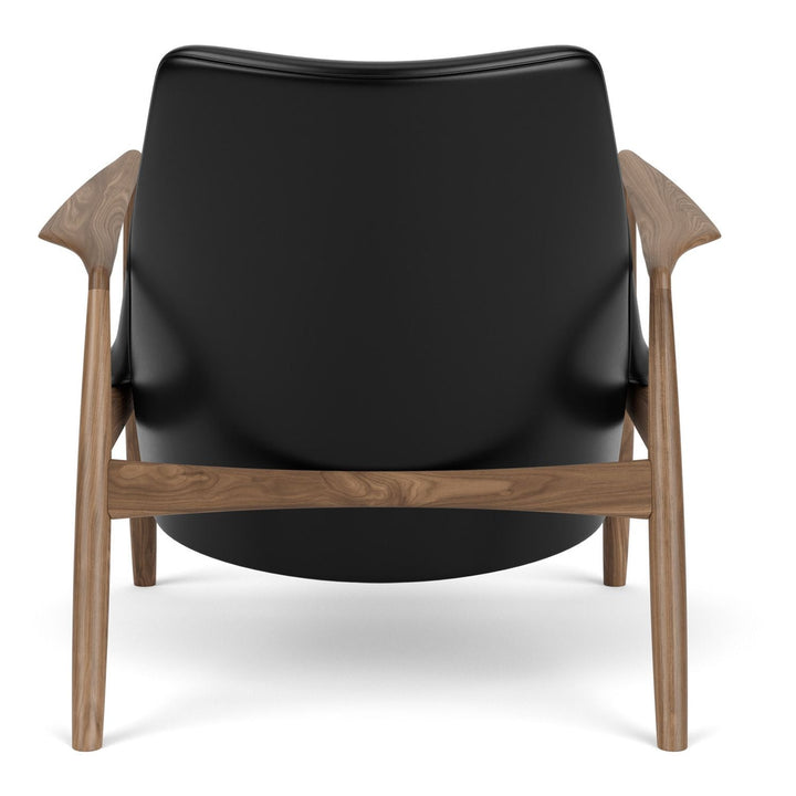 The Seal Low Back Lounge Chair by Audo Copenhagen - Arguably one of Ib Kofod-Larsen's best-known designs, The Seal is an elegant armchair typical of its time – and yet entirely timeless. The angled frame and armrests and leather upholstery put comfort at