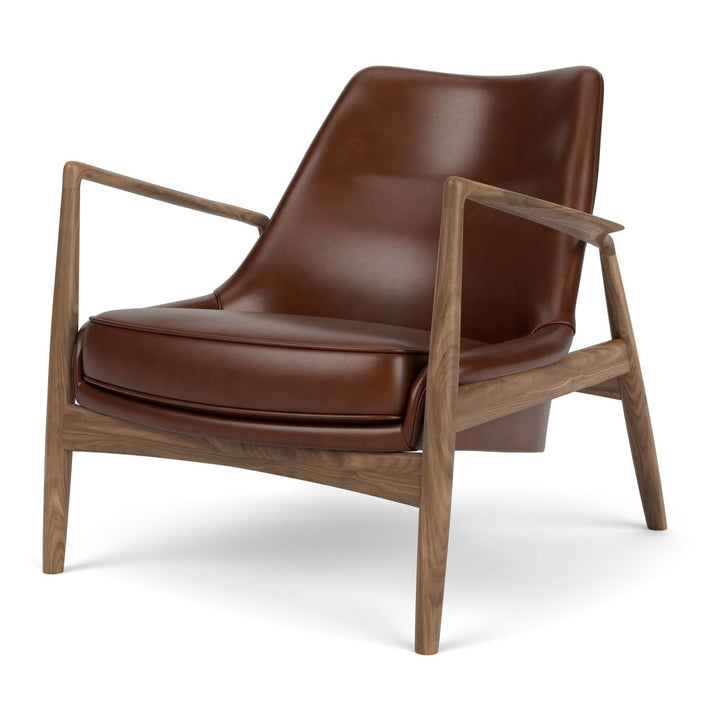The Seal Low Back Lounge Chair by Audo Copenhagen - Arguably one of Ib Kofod-Larsen's best-known designs, The Seal is an elegant armchair typical of its time – and yet entirely timeless. The angled frame and armrests and leather upholstery put comfort at