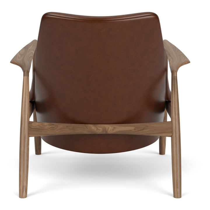 The Seal Low Back Lounge Chair by Audo Copenhagen - Arguably one of Ib Kofod-Larsen's best-known designs, The Seal is an elegant armchair typical of its time – and yet entirely timeless. The angled frame and armrests and leather upholstery put comfort at