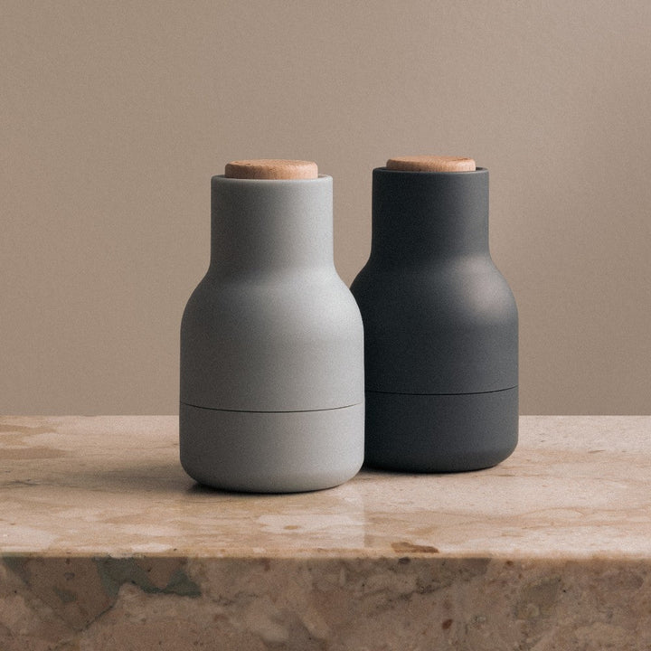 Audo CPH Bottle Grinder, Small by Audo Copenhagen - The Small Bottle Grinders come as a two-piece set of salt and pepper mills, each equipped with a robust ceramic mechanism that efficiently grinds various spices. Designed in a bottle shape that fits comf
