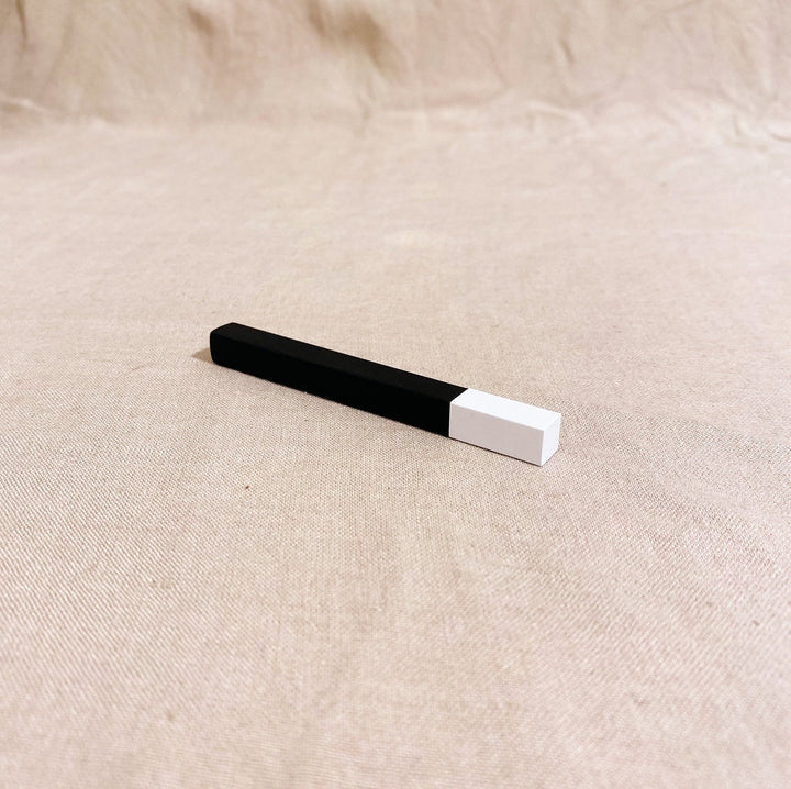 TSUBOTA PEARL Queue Matte Black/White refillable stick lighter on a neutral background