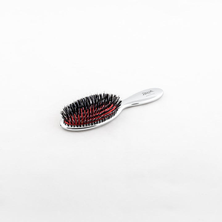 Janeke Silver Nylon/Boar Bristle Hairbrush - 3 Sizes This hairbrush combines both shine and detangling abilities with its unique blend of nylon and boar bristles. It effectively distributes the natural oils from your scalp to the ends of your hair, while