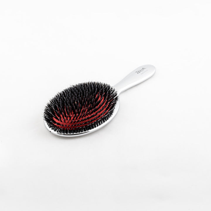 Janeke Silver Nylon/Boar Bristle Hairbrush - 3 Sizes This hairbrush combines both shine and detangling abilities with its unique blend of nylon and boar bristles. It effectively distributes the natural oils from your scalp to the ends of your hair, while