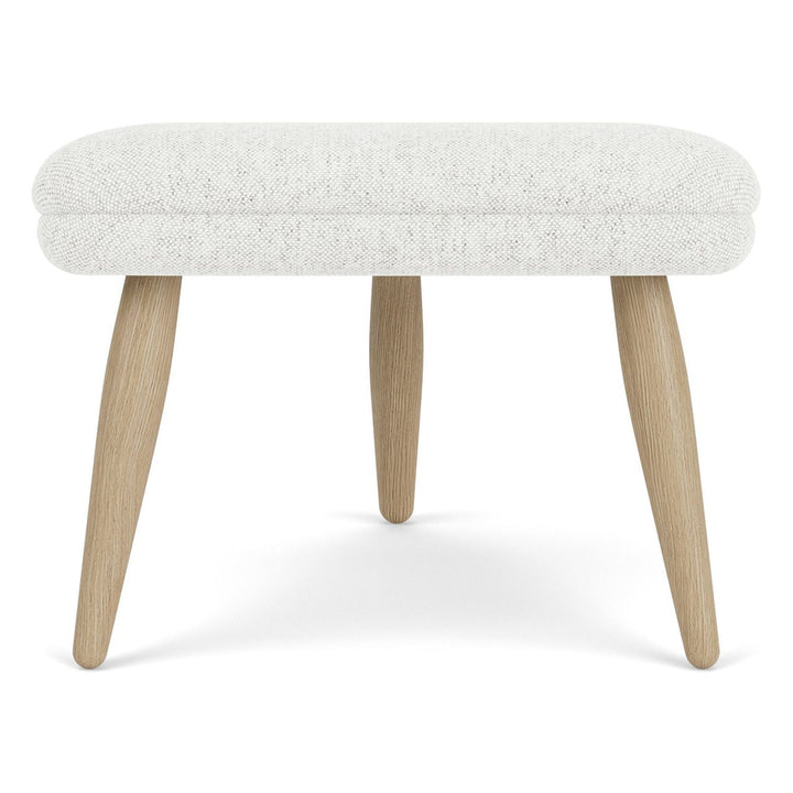 Oda Ottoman by Audo Copenhagen - Designed for use with Arnold Madsen’s Oda Chair but equally purposeful alone, the Oda Ottoman profiles the same careful craft and embracing form, shaped to offer comfortable support when seated. Constructed according to a