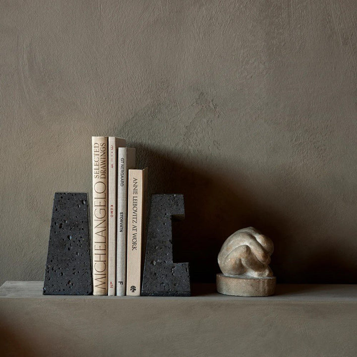 AUDO CPH (ex MENU) Converge Book Ends, Lava Stone by Audo Copenhagen - Designed to hold books in place, the abstract forms of the Converge bookends are shaped from lava stone – A dark and porous material with a textured surface. Use as intended, one at ei