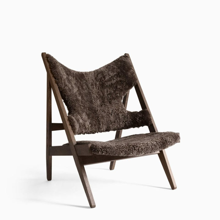 AUDO CPH Knitting Chair - Dark Oak & Sheepskin Shop the iconic AUDO CPH Knitting Lounge Chair, handcrafted in Sweden with luxe sheepskin for supreme comfort & elegance. by Audo Copenhagen Available at beon.com.au | Australian Stock