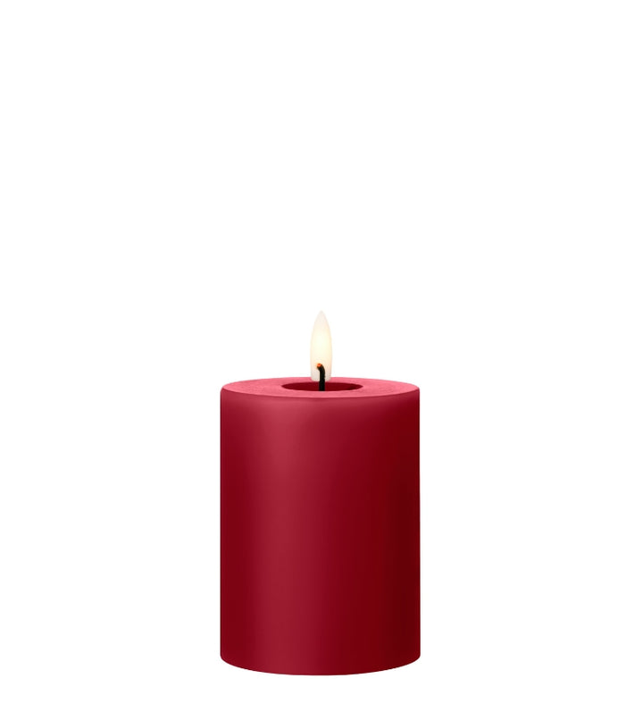 Ester & Erik LED pillar candle in rich red with a lifelike flame, perfect for elegant decor.