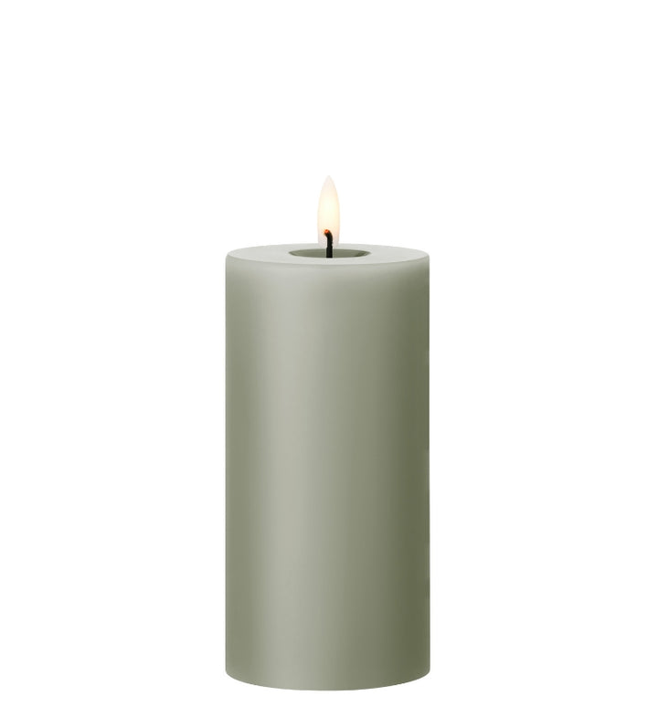 Ester & Erik LED pillar candle in soft green with realistic flame for elegant ambiance.