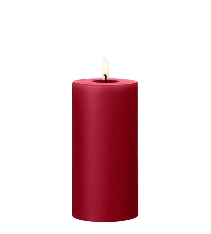 Ester & Erik red LED pillar candle with lifelike glow, perfect for enhancing ambiance in any space.