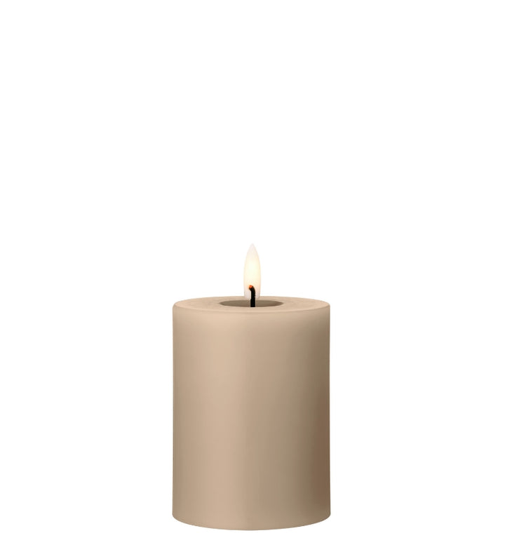 Ester & Erik LED pillar candle in soft beige with lifelike glow, perfect for elegant decor and special occasions.